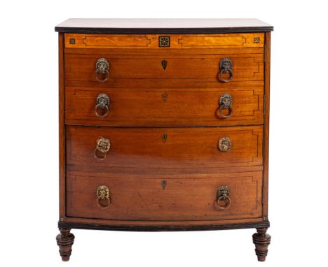 A Regency mahogany and satinwood banded bowfront commode chest; early 19th century; the hinged top with reeded edges; the fro