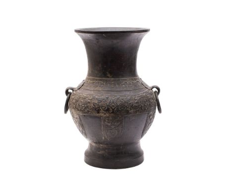 A Chinese bronze archaistic vase, Hu of baluster form with loose ring handles, cast with bands of taotie masks and scrollwork