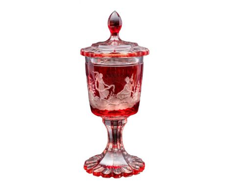 A Bohemian ruby flashed glass goblet and cover on octagonal stem and foot, the similar cover with pointed finial, the bowl en