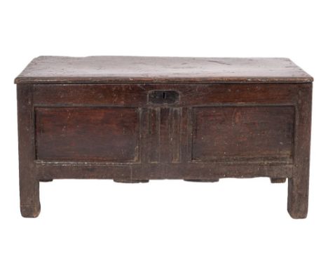An oak coffer, second half 17th century; the hinged cover above a chenneled and twin panel front, on through stiles; 53cm hig