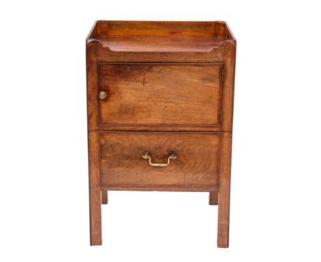 A George III mahogany tray top commode, circa 1770; the three quarter gallery pierced at the sides for handles; above a door 