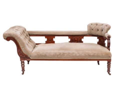 A late Victorian or Edwardian mahogany and upholstered chaise longue, circa 1900; the sloped buttoned back at one side, joine