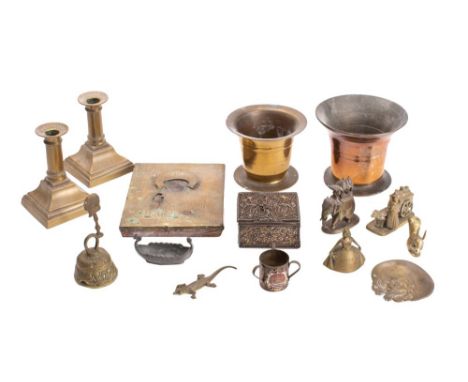 A 19th century bronze pestle of traditional design, a pair of brass candlesticks, a Russian icon Christ Pantocrator, with bra