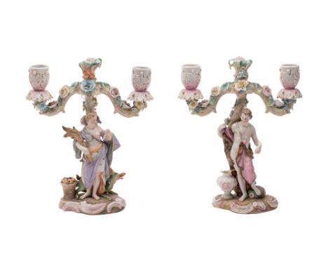 A pair of Meissen-style allegorical figural candlebra the branches applied with flowers and foliage, on rococo mound bases, u