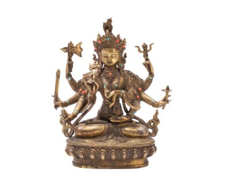 A bronze statue of a Hindu goddess possibly Durga, seated cross legged on a lotus flower base, 22cm high. 