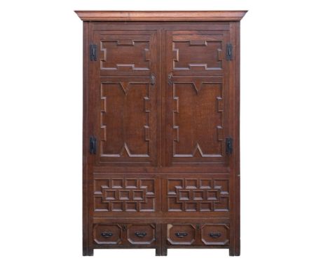 An oak armoire in 17th century style, late 19th century; with ogee moulded cornice above twin panel doors with geometric moul