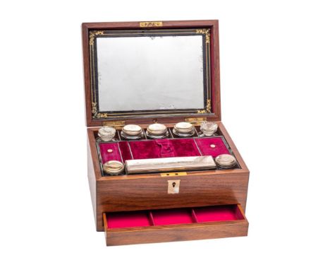 A 19th century mahogany dressing box of rectangular outline, the hinged lid with sprung mirror panel enclosing a lift-out tra
