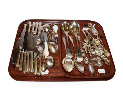 A collection of silver and silver plated flatware, including three Fiddle pattern table-spoons, an Art Deco table-spoons, a q