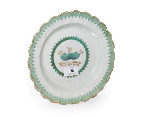 An 18th century Worcester lobed plate, decorated with gilt and French green enamel with a saw tooth border circa 1780, 21.5cm