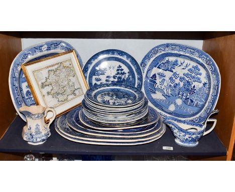 A quantity of blue and white pottery mainly in the Willow pattern, including early 19th century pearlware examples, meat dish