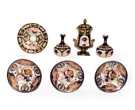 A Royal Crown Derby Imari lidded pedestal urn and cover, 1911, a pair of similar bottle vases, 1929, a saucer and three 19th 