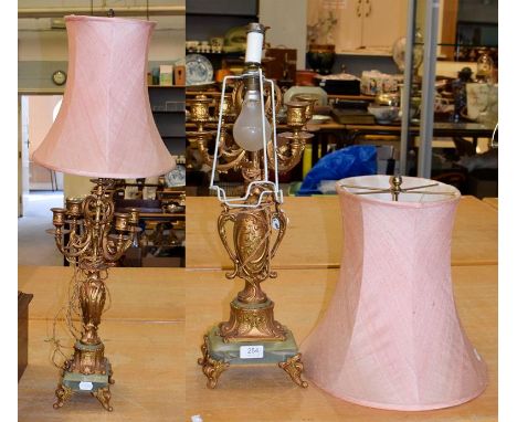 A pair of gilt metal four-branch candelabra on green onyx bases, fitted for electricity, 58.5cm to the fittings (2)