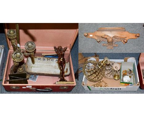 A suitcase containing assorted items including a brass three light candle holder, metal fireside sculpture, iron water bowl m