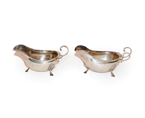 A pair of George V silver sauceboats, by George Howson, Sheffield, 1917, each oval and on three shell-capped feet, with scrol