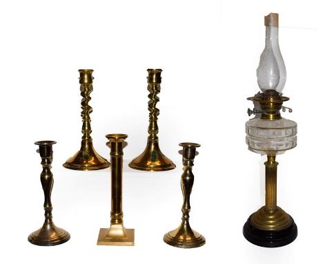 A 19th century brass columnar oil lamp and five various 19th century brass candlesticks