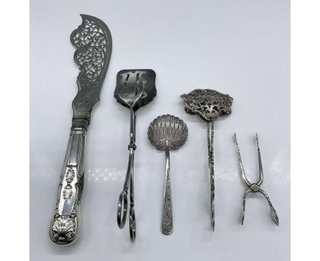 A marvelous set of kitchen utensils featuring a filigree sifter spoon with no markings, small tongs marked NM 830.S, Electro 