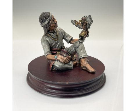 This pewter and bronze figurine depicts a man crafting a Native AmericanÂ&nbsp;Â&nbsp;Kachina doll, with exquisite details de