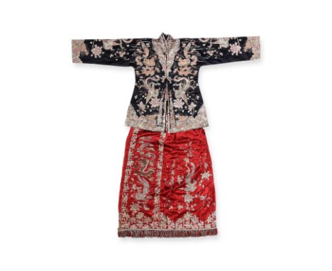 A SILK EMBROIDERED JACKET AND SKIRT
A red silk skirt decorated in gold thread phoenix, peonies, and dragon, a black silk grou