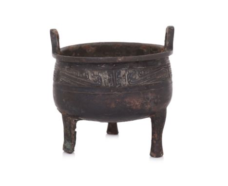 AN INSCRIBED BRONZE TRIPOD VESSEL, DING Cauldron form with loop lugs to everted rim, decorated in band of stylised serpents, 
