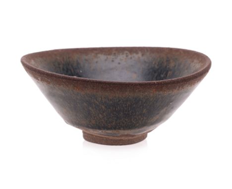 A JIAN 'HARE'S FUR' TEA BOWL
Conical stoneware bowl covered in black glaze with caramel-brown streak running thin across the 