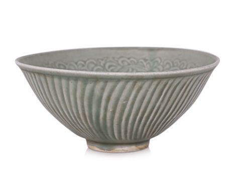 A MOULDED CELADON CHRYSANTHEMUM BOWL
Green glazed bowl with moulded interior and combed sides, in the Northern Song style but