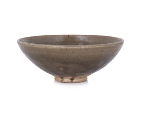 A GREEN-GLAZED CELADON BOWL
Song-Yuan dynasty, neatly potted stoneware with rounded sides covered in transparent olive-green 
