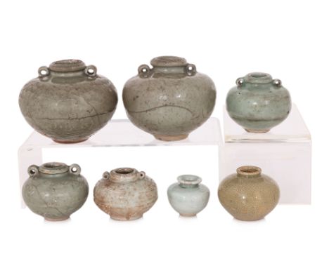 A GROUP OF SEVEN CELADON JARS
Yuan-Ming dynasty, five twin lug celadon moulded underglaze examples, two with dragon decoratio