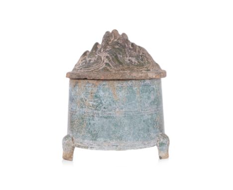 A GREEN-GLAZED HILL JAR AND COVER
Han dynasty, green lead glazed earthenware jar, standing on three short curved feet, the hi