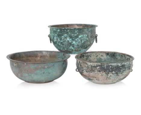 A GROUP OF THREE BRONZE BOWLS
Zhou-Han dynasty, an example decorated with pair of taotie lugs and banding to sides, a heavily