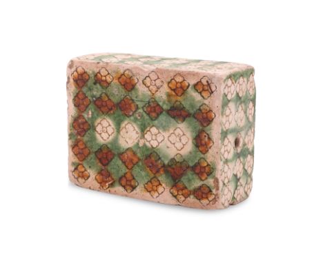 A SANCAI GLAZED 'FLORAL' PILLOW Tang dynasty, rectangular form earthenware decorated in repeating floret pattern, green and y