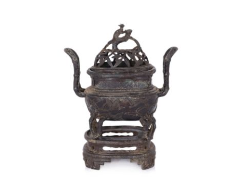 A LARGE BRONZE BAMBOO DECORATED CENSER, WITH COVER AND STAND The ovoid body decorated in raised bamboo leaves and shoots, bam