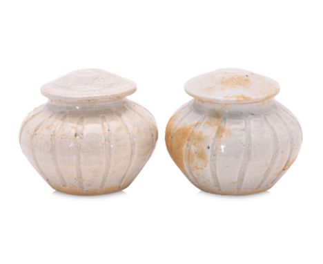 A PAIR OF QINGBAI GLAZED JARS
Song-Yuan dynasty, of compressed globular form with incised lobed sides and domed covers, cover
