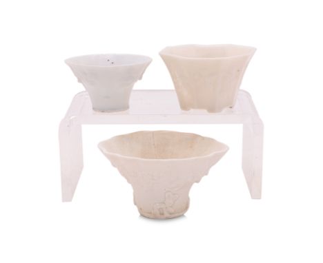 A GROUP OF THREE BLANC DE CHINE MOULDED LIBATION CUPS
Qing dynasty, an octagonal example with moulded decoration of eight fig