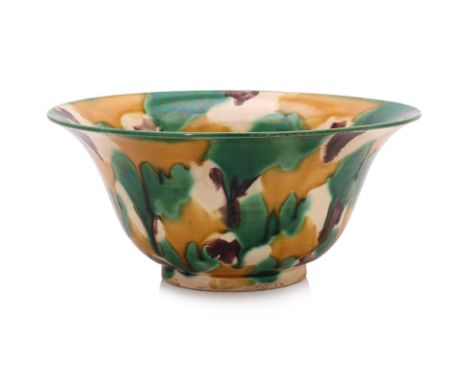 A SANCAI GLAZED BOWL
Qing dynasty, wide flanged rim, cream glaze decorated in green, amber and brown, raised foot rim
19cm di