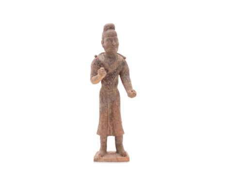A PAINTED EARTHENWARE MODEL OF A SOGDIAN GROOM
Terracotta figure modelled standing wearing robe, his arms raised as if holdin