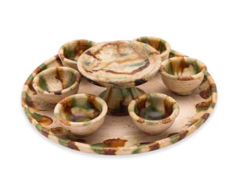 A SANCAI WARE SET OF CUPS WITH TRAY AND FOOTED DISH
Tang dynasty, circular tray, a set of six cups, and a footed dish, all gl