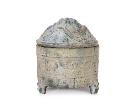 A GREEN GLAZED HILL JAR AND COVER
Han dynasty, green lead glazed earthenware jar, decorated to the exterior sides with moulde