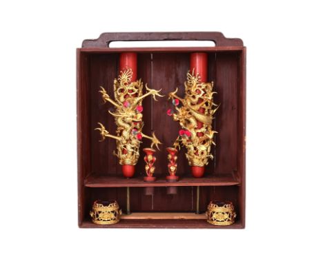 A PAIR OF ELABORATE CARVED GILTWOOD DRAGON CANDLESTICKS Each decorated with a four clawed dragon and various figures, housed 