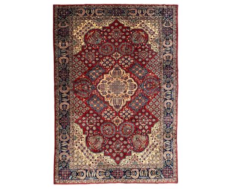 Persian red ground carpet, shaped medallion decorated with central latticework of flower heads, the field decorated in segmen
