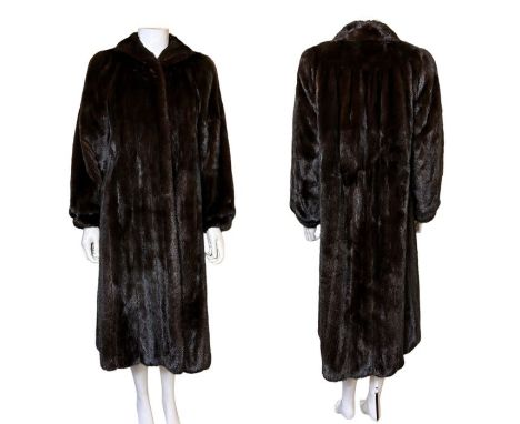 1960s-70s chocolate mink coat with silk and velvet lining. The coat has full sleeves that are tightly cuffed at the wrist and