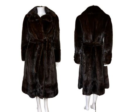 A dark chocolate mink coat C1970s, high quality part waisted design with tie belt. Fur hook fastenings and large collars. 42 