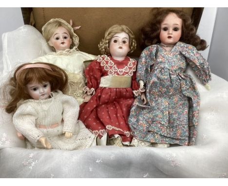 Antique Bisque Head dolls ; selection of smaller group of 4 dolls to include later clothes .(4)