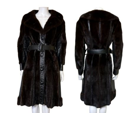 A 1970s leather and dark chocolate mink panel coat with button fastenings, belt waist and large collars . Labelled "black Fan