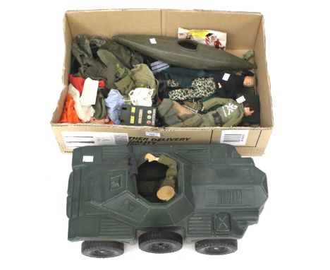 An assortment of Action Man figures and accessories. Including a tank, kayak, clothes, an equipment manual, etc.