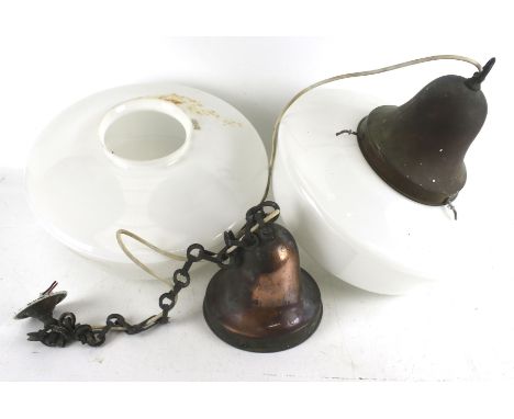 A pair of vintage ceiling lights. The white glass shades attached to copper mounts and chains, Diameter 34cm