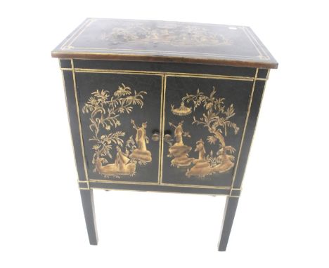 A contemporary Chinese style cabinet. Decorated with gilt figures on a black ground, the doors opening to reveal a single she