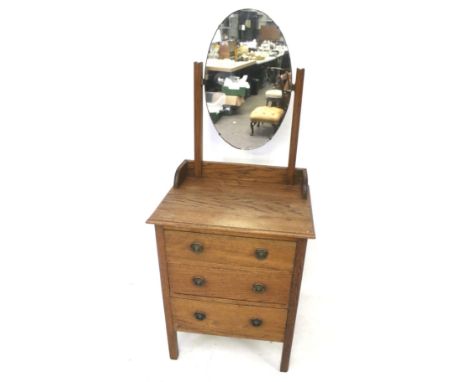 A vintage oak chest of three drawers with an oval mirror. H148cm
