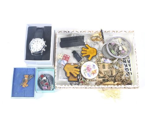 An assortment of costume jewellery and a watch. Including a silver mounted ring, enamel badge, 'Tree of Life' pendants, etc.