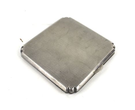 A silver engine-turned square compact. With shaped corners, mark of Suckling Ltd, Birmingham 1940, approx. 6.75cm overall (2 