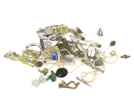 A collection of period jewellery. Including; a butterfly-wing round pendant; a carved jet oval brooch; a gold-plated curb-lin